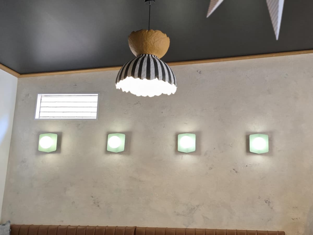 Commercial creative lighting installation with custom pendant lights and decorative wall features