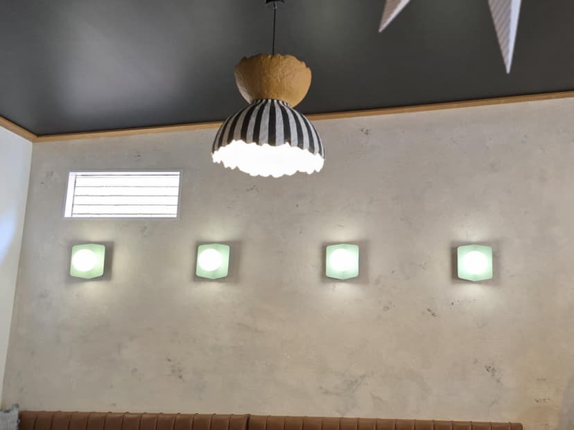 Designer pendant light installation with decorative wall features and ambient lighting